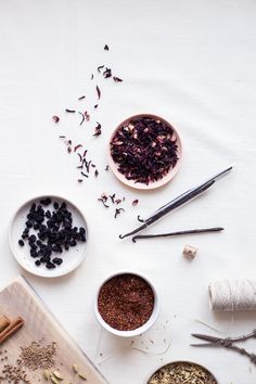 various bowls and spoons filled with different types of spices