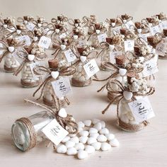 small glass jars filled with marshmallows tied in twine