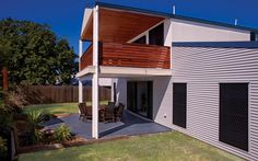 a modern house with an attached deck and patio