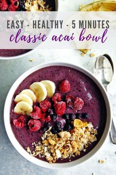 two bowls filled with fruit and granola on top of a table