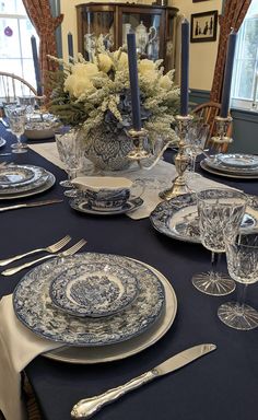 the table is set with blue and white china