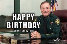 a man in uniform sitting at a desk next to a book with the caption happy birthday sheriff grady