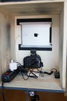 an apple computer monitor sitting on top of a wooden shelf