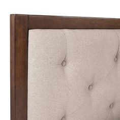 a close up view of the back of a headboard with buttons and wood trim