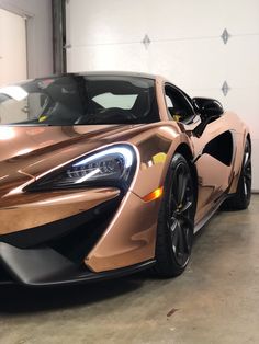 an orange sports car parked in a garage