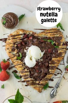 strawberry nutella galette with chocolate sauce and whipped cream in the shape of a heart