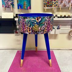 a blue planter sitting on top of a pink rug