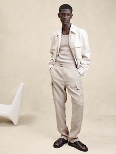 We reinterpreted the classic cargo pant with the details of an expertly tailored trouser and side adjuster tabs at the waist for a perfect fit.  For fabric, we reached for certified European linen, a fabric we love for its lived-in look and its ability to stay cool and crisp even in heat and humidity.  Tailored Slim Fit: Mid-rise.  Tapered slim leg.  Zip fly with button-tab closure.  Front, back and side cargo pockets.  Trouser crease.  Unlined.  Tailored Slim Fit: Mid-rise.  Tapered slim leg.  Full length.  Inseams: Regular 31. 5" Model: Size 32 Regular, 6'2" (188cm). Dungaree Jeans, Loungewear Shorts, Mens Chinos, European Linens, Boys Coat, Black Men Fashion, Pantalon Cargo, Workwear Dress, Cargo Pant