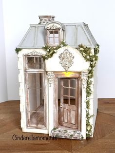 an old doll house with ivy growing on the roof and windows is shown in this image