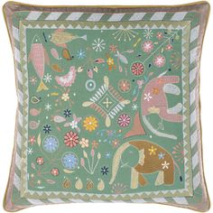 a green pillow with an elephant and flowers on it