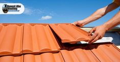 a man is working on an orange roof