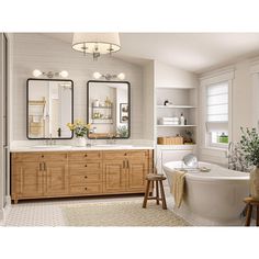 a bathroom with two sinks, a tub and large mirrors on the wall above it