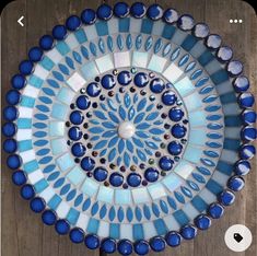 a blue and white plate sitting on top of a wooden table next to a cell phone