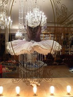 a chandelier in the shape of a ballerina's tutu with lights around it