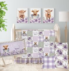 a baby crib bedding set with purple flowers and two cows on the wall