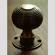 a close up of a metal object on a wooden floor with light shining in the background