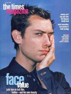 a man with his hand to his face on the cover of time magazine, which features an image of him