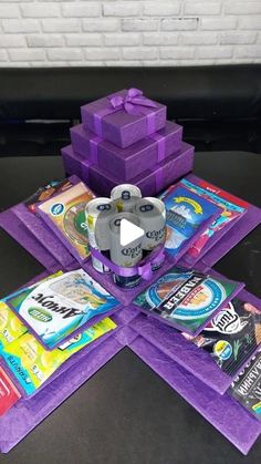 a video game is being played on the table with purple boxes and other items around it