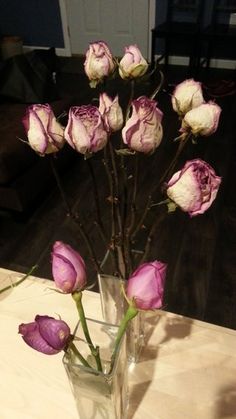 a vase filled with purple flowers on top of a table