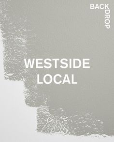 the words westside local are painted on a gray wall with white paint and black brush strokes