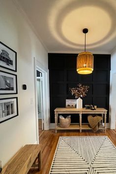 a living room filled with furniture and a rug on the floor next to a table