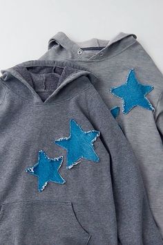 two gray sweatshirts with blue stars on them