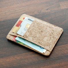 a cork wallet with credit cards sticking out of it