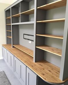 an empty room with some shelves and cupboards on the wall next to each other