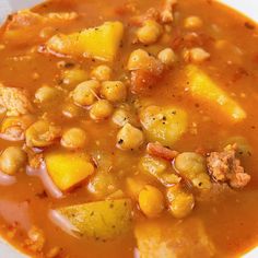 a white bowl filled with soup and vegetables