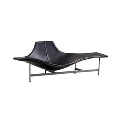 a black leather chaise lounge chair with metal legs