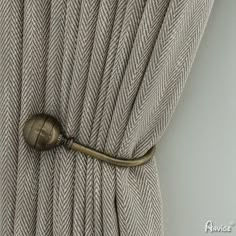 a close up of a curtain with a metal hook on it's center piece