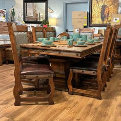 a dining room table with chairs and plates on it in the middle of a store