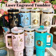 many different colored coffee mugs with gold trimming on them and the words laser engraved tumbler