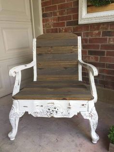 an old white chair sitting in front of a brick wall