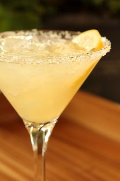 a close up of a drink on a table with a wooden surface in the background