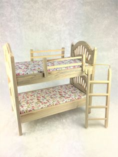 a wooden bunk bed with floral print sheets and ladders on the bottom level, against a white background