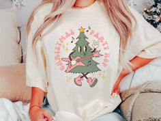 This rockin' tree retro Christmas shirt is perfect for your Christmas party outfit or Christmas pjs. The tree playing guitar and singing Christmas Party Hop in groovy font is sure to get you in the holiday spirit. This shirt is also great for music teachers or anyone who loves oversized retro Christmas shirts or Christmas pjs. Comfort Colors introduces its garment-dyed t-shirt; a fully customizable tee made 100% with ring-spun cotton. The soft-washed, garment-dyed fabric brings extra coziness to Guitar And Singing, Groovy Font, Music Teachers, Christmas Party Outfit, Christmas Tree Shirt, Christmas Pjs, Tree Shirt