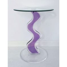 a glass table topped with a purple wavy design