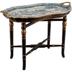 an ornately decorated tray sits on a wooden stand with gold trimmings and blue accents