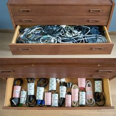 an open drawer with wires and cords in it