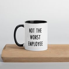 a black and white coffee mug that says not the worst employee