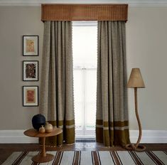 a living room scene with focus on the curtains and floor lamp in the foreground