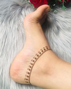 a woman's foot with a small tattoo on the side of her left leg