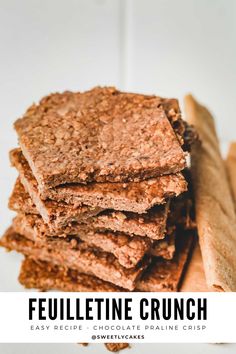 a stack of crackers sitting on top of a white plate next to cinnamon sticks