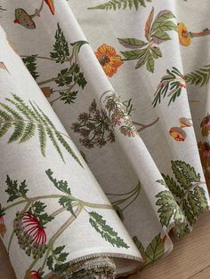 an image of a curtain with flowers and leaves on it