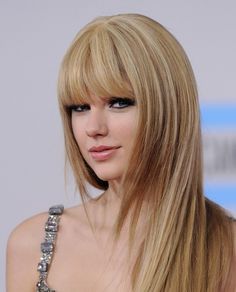 a woman with long blonde hair and bangs