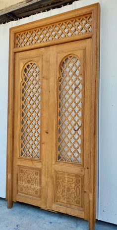 an old wooden door with intricate carvings on the front and side doors are made out of wood