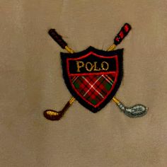 embroidered polo shirt with two golf clubs on it