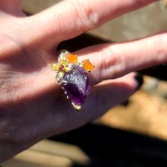 This Is A New Gorgeous Raw Amethyst Feature Stone Set In .925 Sterling Silver With A Lovely Little Gold Flower And Findings. The Accent Stones Are Fire Opals And A Cute Little Ruby In The Flower. This Is A Size 7.5 Ring Hand Forged By Avelon For Her Dark Kharma Collection Of 2022. Please Ask Questions And Make An Offer. I Can't Say Yes If You Don't Ask! Unique Multi-stone Purple Amethyst Ring, Unique Purple Multi-stone Amethyst Ring, Purple Multi-stone Amethyst Crystal Ring, Purple Amethyst Multi-stone Crystal Ring, Fire Opals, Ring Hand, Raw Amethyst, Gold Flower, Say Yes