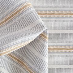 an upholstered fabric with yellow and white stripes